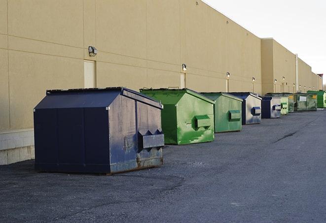 large construction dumpster positioned on a city street in Allston